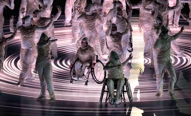 Dancers perform during the opening ceremony at the 2026 Winter Paralympics, in Verona, Italy, Friday, March 6, 2026. (AP Photo/Luca Bruno)