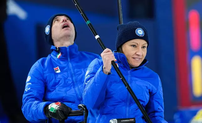 Italy's Orietta Berto, left, and Paolo Ioriatti compete against China during a wheelchair curling mixed doubles match at the 2026 Winter Paralympics in Cortina d'Ampezzo, Italy, Thursday, March 5, 2026. (AP Photo/Evgeniy Maloletka)
