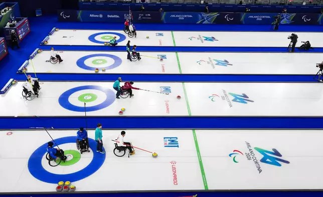Athletes compete during wheelchair curling mixed doubles matches at the 2026 Winter Paralympics, in Cortina d'Ampezzo, Italy, Thursday, March 5, 2026. (AP Photo/Evgeniy Maloletka)