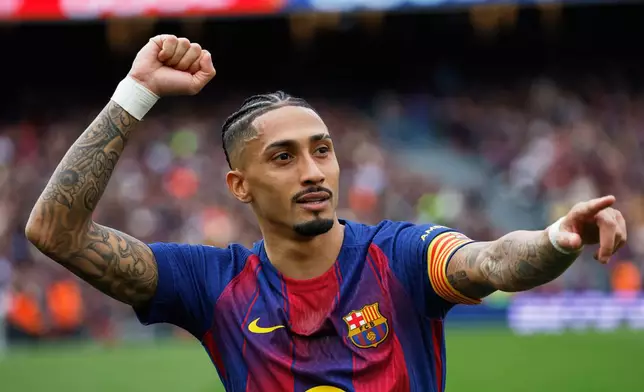 Barcelona's Raphinha celebrates after scoring during the Spanish La Liga soccer match between Barcelona and Sevilla in Barcelona, Spain, Sunday, March 15, 2026. (AP Photo/Joan Monfort)