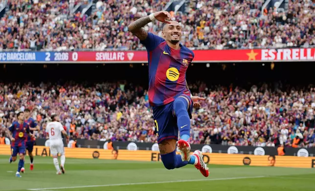 Barcelona's Raphinha celebrates after scoring during the Spanish La Liga soccer match between Barcelona and Sevilla in Barcelona, Spain, Sunday, March 15, 2026. (AP Photo/Joan Monfort)