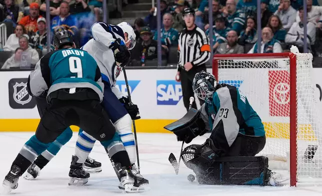 San Jose Sharks goaltender Alex Nedeljkovic (33) stops a shot during the second period of an NHL hockey game against the Winnipeg Jets, Sunday, March 1, 2026, in San Jose, Calif. (AP Photo/Godofredo A. Vásquez)