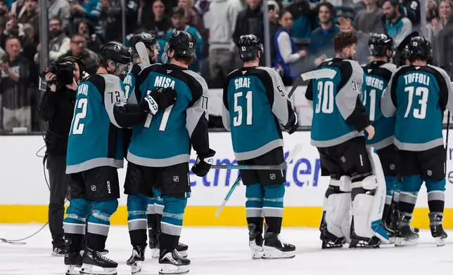 San Jose Sharks center Michael Misa (77) is congratulated by left wing William Eklund (72) after scoring the game-winning goal during overtime of an NHL hockey game against the Winnipeg Jets, Sunday, March 1, 2026, in San Jose, Calif. (AP Photo/Godofredo A. Vásquez)
