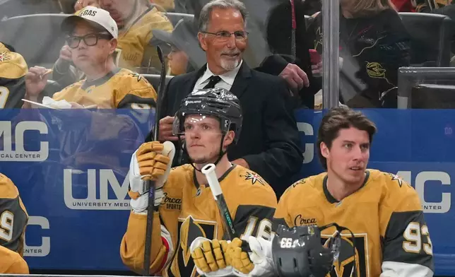 Vegas Golden Knights head coach John Tortorella, center top, looks on during the first period of an NHL hockey game against the Vancouver Canucks, Monday, March 30, 2026, in Las Vegas. (AP Photo/Candice Ward)