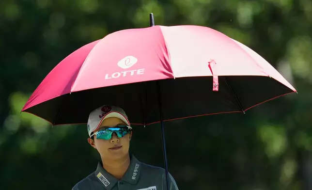 Hyo Joo Kim, of South Korea, carries an umbrella as she walks to the third tee during the final round of the LPGA Fortinet Founders Cup golf tournament, Sunday, March 22, 2026, in Menlo Park, Calif. (AP Photo/Godofredo A. Vásquez)