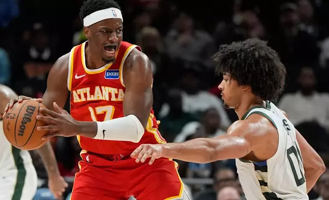 Atlanta Hawks forward Onyeka Okongwu (17) drives against Milwaukee Bucks center Jericho Sims (00) during the second half of an NBA basketball game, Saturday, March 14, 2026, in Atlanta. (AP Photo/Mike Stewart)