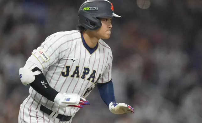 Japan's Shohei Ohtani runs as he hits a single home run during the first inning against Venezuela of a World Baseball Classic quarterfinal game, Saturday, March 14, 2026, in Miami. (AP Photo/Lynne Sladky)