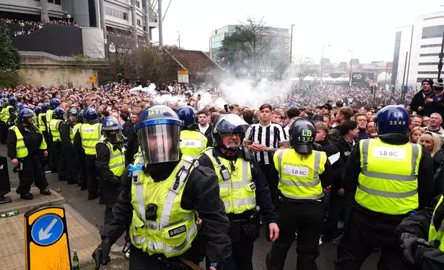 Police separate Newcastle United and Sunderland fans ahead of the Premier League match between Newcastle and Sunderland outside St James' Park, Newcastle upon Tyne, England, Sunday March 22, 2026. (Owen Humphreys/PA via AP)