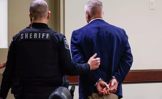 Colin Gray, the father of Apalachee High School shooting suspect Colt Gray, is handcuffed and escorted out of the room after jury deliberations at his trial at Barrow County Courthouse in Winder, Ga., Tuesday, March 3, 2026. (Abbey Cutrer/Atlanta Journal-Constitution via AP, Pool)