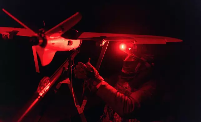 A soldier of the 127th Separate Territorial Brigade launches a drone to search for Russian attack drones at the front line in the Kharkiv region Saturday, March 14, 2026. (AP Photo/Nikoletta Stoyanova)