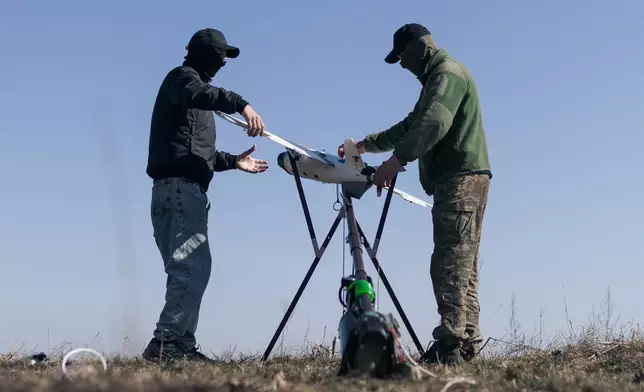 Soldiers of the 127th Separate Territorial Brigade launch a drone to search for Russian attack drones at the front line in the Kharkiv region Friday, March 13, 2026. (AP Photo/Nikoletta Stoyanova)
