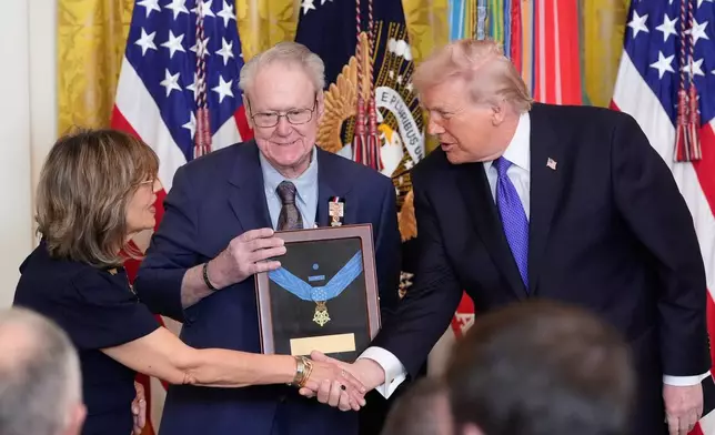 President Donald Trump posthumously presents the Medal Honor to Robert and Linda Ollis, parents of Staff Sergeant Michael Ollis, during a ceremony in the East Room of the White House, Monday, March 2, 2026, in Washington. (AP Photo/Alex Brandon)