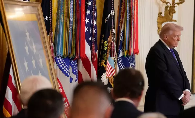 President Donald Trump stands during a prayer before a Medal of Honor ceremony in the East Room of the White House, Monday, March 2, 2026, in Washington. (AP Photo/Mark Schiefelbein)