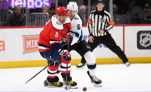 Utah Mammoth defenseman John Marino (6) battles for the puck against Washington Capitals left wing Alex Ovechkin (8) during the second period of an NHL hockey game, Tuesday, March 3, 2026, in Washington. (AP Photo/Nick Wass)