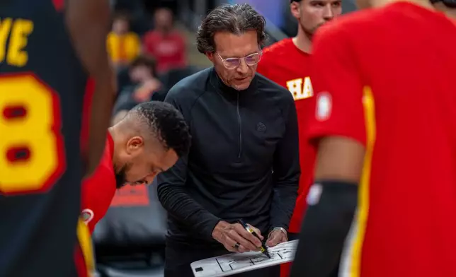 Atlanta Hawks head coach Quin Snyder, center, calls a play during the first half of an NBA basketball game against the Sacramento Kings, Saturday, March 28, 2026, in Atlanta. (AP Photo/Erik Rank)