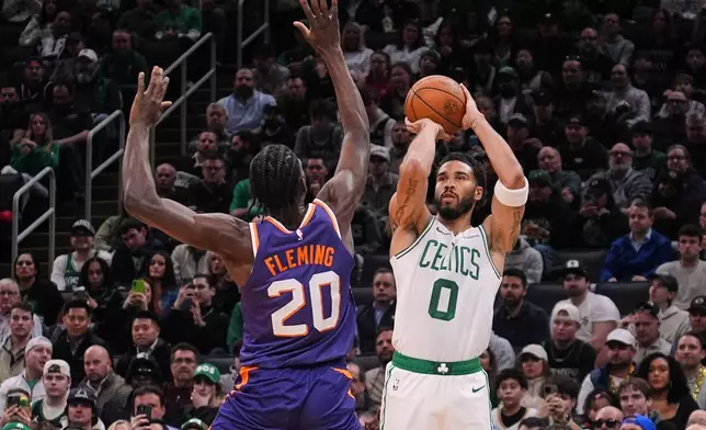 Boston Celtics forward Jayson Tatum (0) takes a 3-point shot over Phoenix Suns forward Rasheer Fleming (20) during the first half of an NBA basketball game, Monday, March 16, 2026, in Boston. (AP Photo/Charles Krupa)