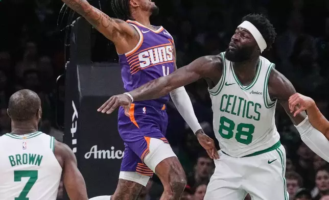 Phoenix Suns guard Jalen Green (4) lines up a dunk against Boston Celtics center Neemias Queta (88) during the first half of an NBA basketball game, Monday, March 16, 2026, in Boston. (AP Photo/Charles Krupa)