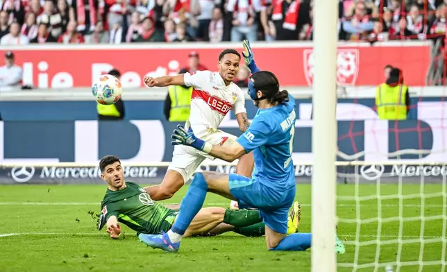 Stuttgart's Nikolas Nartey, center, scores during the German Bundesliga soccer match between VfB Stuttgart and VfL Wolfsburg in Stuttgart, Germany, Sunday, March 1, 2026. (Harry Langer/dpa via AP)