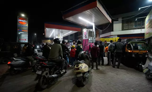 FILE - Motorists wait to get fuel at a pump, fearing a possible fuel shortage due to the US Iran war, in Srinagar, Indian controlled Kashmir, Wednesday, March 25, 2026. (AP Photo/Mukhtar Khan, file)