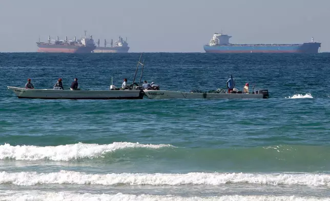 FILE - Fishermen work in front of oil tankers south of the Strait of Hormuz Jan. 19, 2012, offshore the town of Ras Al Khaimah in United Arab Emirates. (AP Photo/Kamran Jebreili, File)