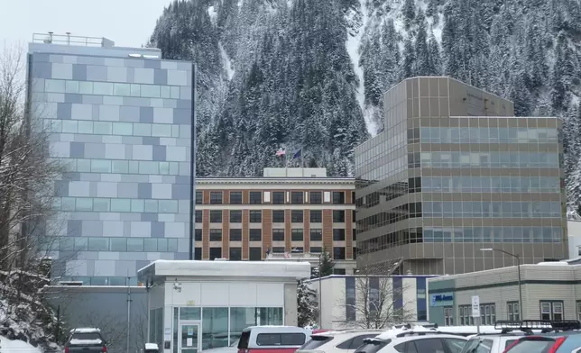 The building housing the director's office of the Alaska Division of Elections, at left, is photographed Thursday, March 19. 2026, in Juneau, Alaska, with the state Capitol and state court building also shown. (AP Photo/Becky Bohrer)