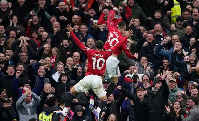 Manchester United's Benjamin Sesko and Matheus Cunha celebrate after a goal during the Premiier League soccer match between Manchester United and Aston Villa in Manchester, England, Sunday, March 15, 2026. (AP Photo/Dave Thompson)