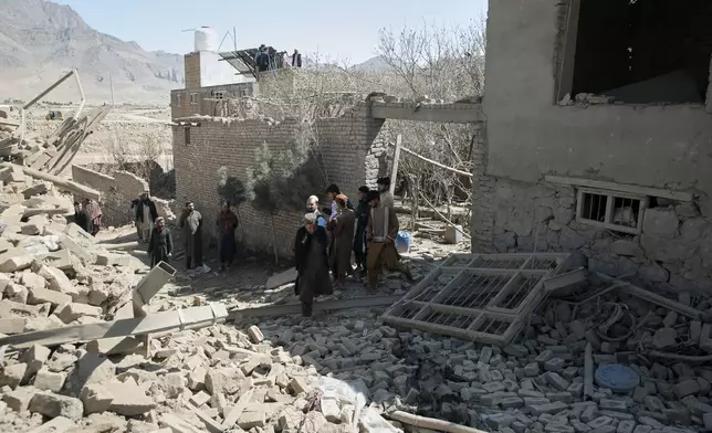 Residents inspect the site of a strike in Kabul, Afghanistan, Friday, March 13, 2026. (AP Photo/Barackatullah Popal)