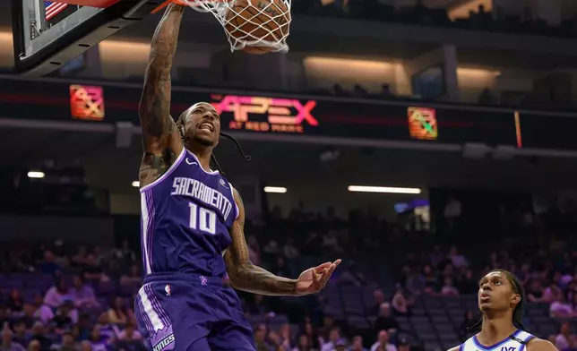 Sacramento Kings guard DeMar DeRozan (10) dunks the ball over Utah Jazz forward Cody Williams (5) during the second half of an NBA basketball game in Sacramento, Calif., Sunday, March 15, 2026. (AP Photo/Randall Benton)