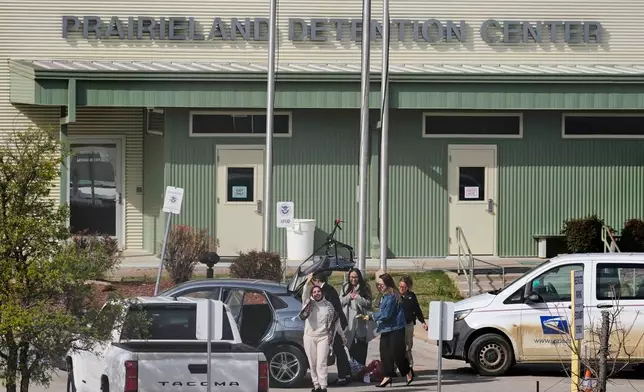 Leqaa Kordia, with hands raised, waves to supporters after being released from the Prairieland Detention Center in Alvarado, Texas, Monday, March 16, 2026. (AP Photo/Tony Gutierrez)