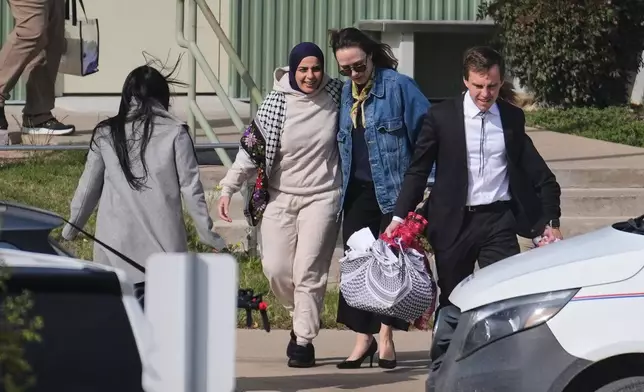 Leqaa Kordia, second from left, walks with her legal team after being released from the Prairieland Detention Center in Alvarado, Texas, Monday, March 16, 2026. (AP Photo/Tony Gutierrez)