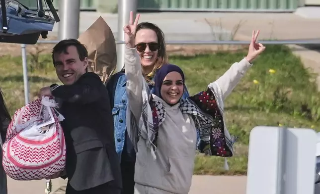 Leqaa Kordia, with hands raised, stands by members of her legal team as she waves to supporters after being released from the Prairieland Detention Center in Alvarado, Texas, Monday, March 16, 2026. (AP Photo/Tony Gutierrez)