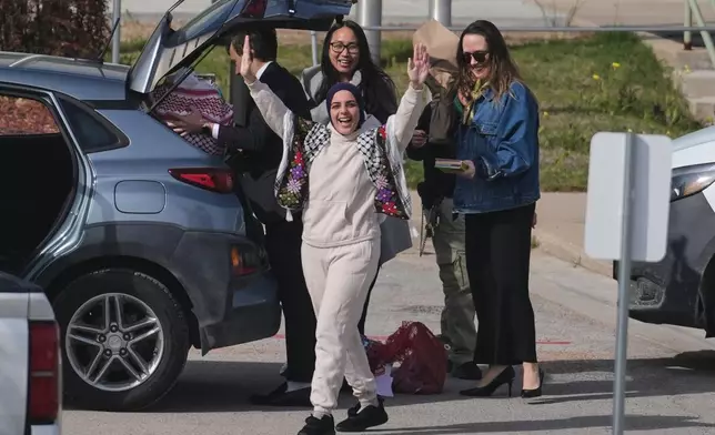 Leqaa Kordia, with hands raised, waves to supporters after being released from the Prairieland Detention Center in Alvarado, Texas, Monday, March 16, 2026. (AP Photo/Tony Gutierrez)