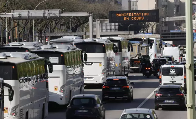 Protesting truck and bus drivers slow traffic down along Paris' ring road to denounce higher fuel prices, Monday, March 30, 2026. (AP Photo/Thibault Camus)
