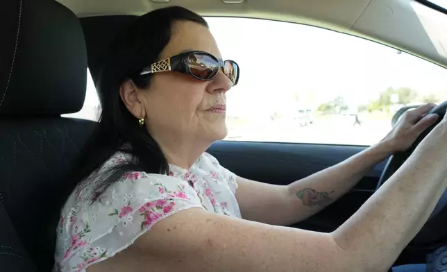 Leslie Sherman-Shafer, an Uber driver, drives her car in Alameda, Calif, March 23, 2026. (AP Photo/Terry Chea)