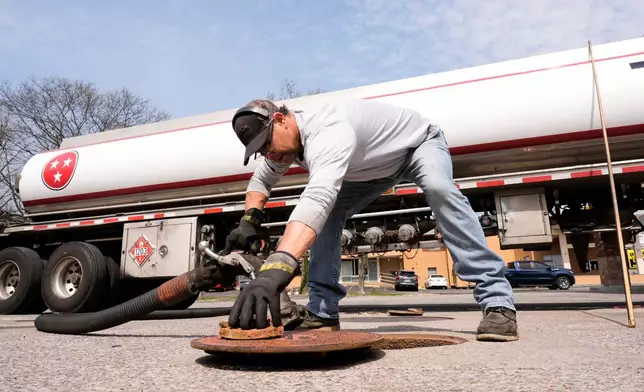 Fuel transport truck driver Chad Middleton refills a gas station Wednesday, March 25, 2026, in Kingston Springs, Tenn. (AP Photo/George Walker IV)