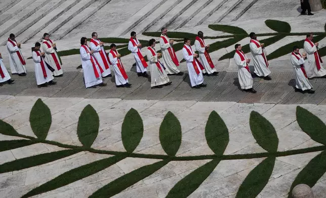 Priests attend Mass presided over by Pope Leo XIV in St. Peter's Square at the Vatican on the Catholic feast of Palm Sunday, commemorating Jesus' arrival in Jerusalem, Sunday, March 29, 2026. (AP Photo/Alessandra Tarantino)