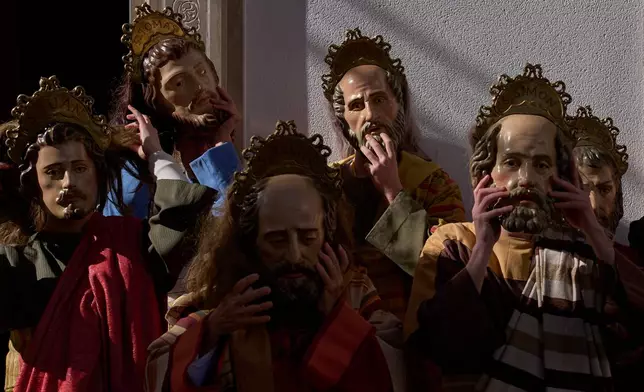 Penitents of the 'Pollinita' brotherhood, dressed in a typical Apostle costumes pose for a picture ahead the Holy Week procession in Cabra, southern Spain, Sunday, March 29, 2026. (AP Photo/Manu Fernandez)