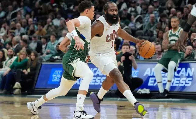 Cleveland Cavaliers' James Harden (1) drives to the basket against Milwaukee Bucks' Ryan Rollins during the first half of an NBA basketball game, Tuesday, March 17, 2026, in Milwaukee. (AP Photo/Aaron Gash)
