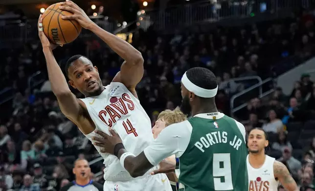 Cleveland Cavaliers' Evan Mobley (4) drives to the basket against Milwaukee Bucks' Bobby Portis during the first half of an NBA basketball game, Tuesday, March 17, 2026, in Milwaukee. (AP Photo/Aaron Gash)