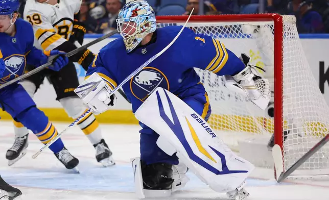 Buffalo Sabres goaltender Ukko-Pekka Luukkonen (1) watches the puck in traffic during the second period of an NHL hockey game against the Boston Bruins Wednesday, March 25, 2026, in Buffalo, N.Y. (AP Photo/Jeffrey T. Barnes)