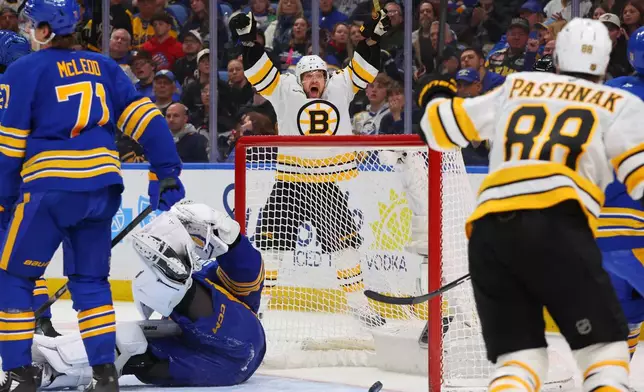 Boston Bruins left wing Viktor Arvidsson (71) ,center, celebrates his goal during the second period of an NHL hockey game against the Buffalo Sabres Wednesday, March 25, 2026, in Buffalo, N.Y. (AP Photo/Jeffrey T. Barnes)
