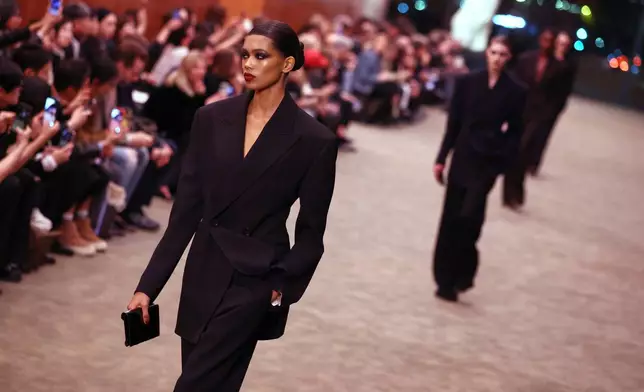 Models wear creations from the Saint Laurent Fall/Winter 2026-2027 Women's collection presented in Paris, Tuesday, March 3, 2026. (AP Photo/Tom Nicholson)