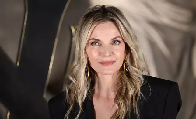 Michelle Pfeiffer poses for photographers upon arrival for the Saint Laurent Fall/Winter 2026-2027 Women's collection presented in Paris, Tuesday, March 3, 2026. (AP Photo/Tom Nicholson)