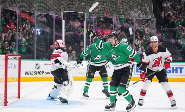 Dallas Stars center Wyatt Johnston (53) reacts after scoring a goal on New Jersey Devils goaltender Jake Allen (34) during the first period of an NHL hockey game Tuesday, March 24, 2026, in Dallas. (AP Photo/Julio Cortez)