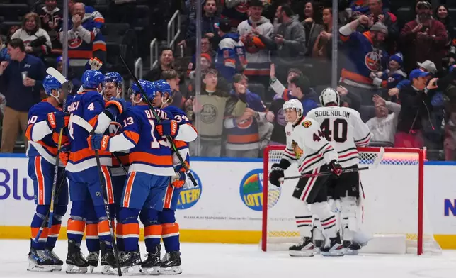 The New York Islanders celebrate a goal by Calum Ritchie during the third period of an NHL hockey game against the Chicago Blackhawks Tuesday, March 24, 2026, in Elmont, N.Y. (AP Photo/Frank Franklin II)