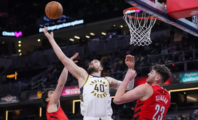 Indiana Pacers center Ivica Zubac (40) grabs a rebound over Portland Trail Blazers center Donovan Clingan (23) during the first half of an NBA basketball game in Indianapolis, Wednesday, March 18, 2026. (AP Photo/Michael Conroy)