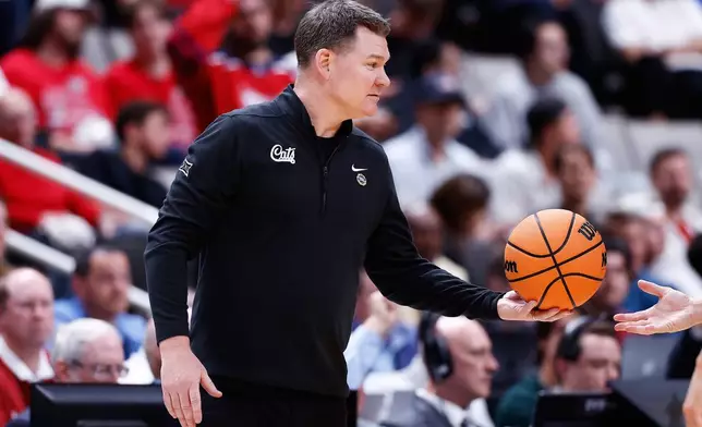 Arizona head coach Tommy Lloyd hands the ball to a referee during the second half in the Sweet 16 of the NCAA college basketball tournament against Arkansas, Thursday, March 26, 2026, in San Jose, Calif. (AP Photo/Kelley L Cox)