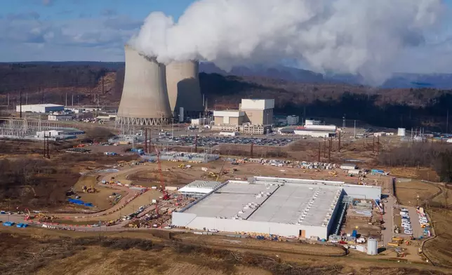 FILE - A data center owned by Amazon Web Services, front right, is under construction next to the Susquehanna nuclear power plant in Berwick, Pa., Jan. 14, 2025. (AP Photo/Ted Shaffrey, File)