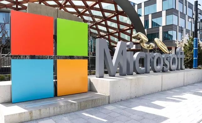 FILE - A Microsoft sign and logo are displayed at the company's headquarters April 4, 2025, in Redmond, Wash. (AP Photo/Jason Redmond, File)