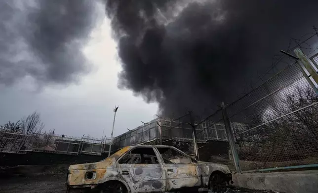 A thick plume of smoke rises from an oil storage facility hit by a U.S.-Israeli strike late Saturday in Tehran, Iran, Sunday, March 8, 2026. (AP Photo/Vahid Salemi)